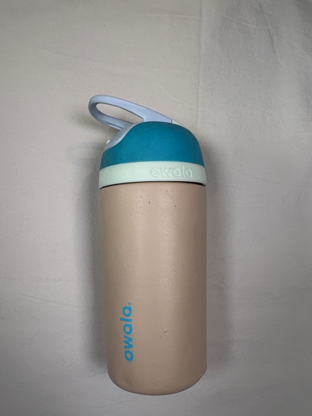 Owala Insulated Bottle in Beige with Teal and Mint Lid